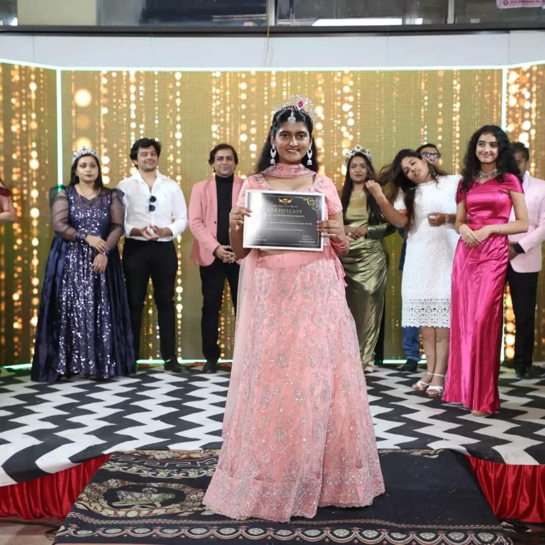 Pageant winner with her certificate on stage
